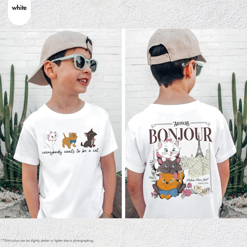 May include: White t-shirt featuring cartoon cats with the text "everybody wants to be a cat" on the front. The back of the shirt has the word "Bonjour" and the text "Aristocats" with a picture of the Eiffel Tower and more cartoon cats.