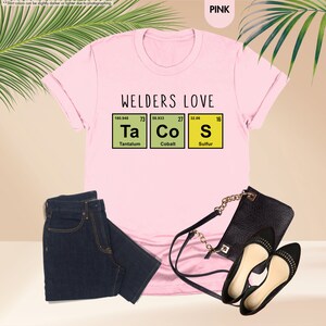 a t - shirt that says welders love tacos and a pair of