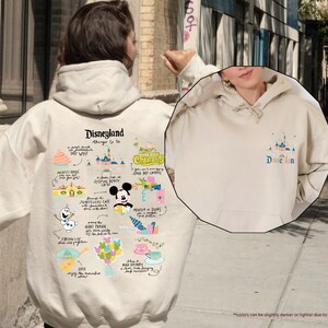 a person wearing a mickey mouse hoodie on a city street