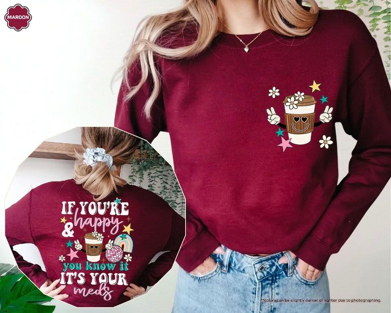 a woman wearing a sweater with a cup of coffee on it