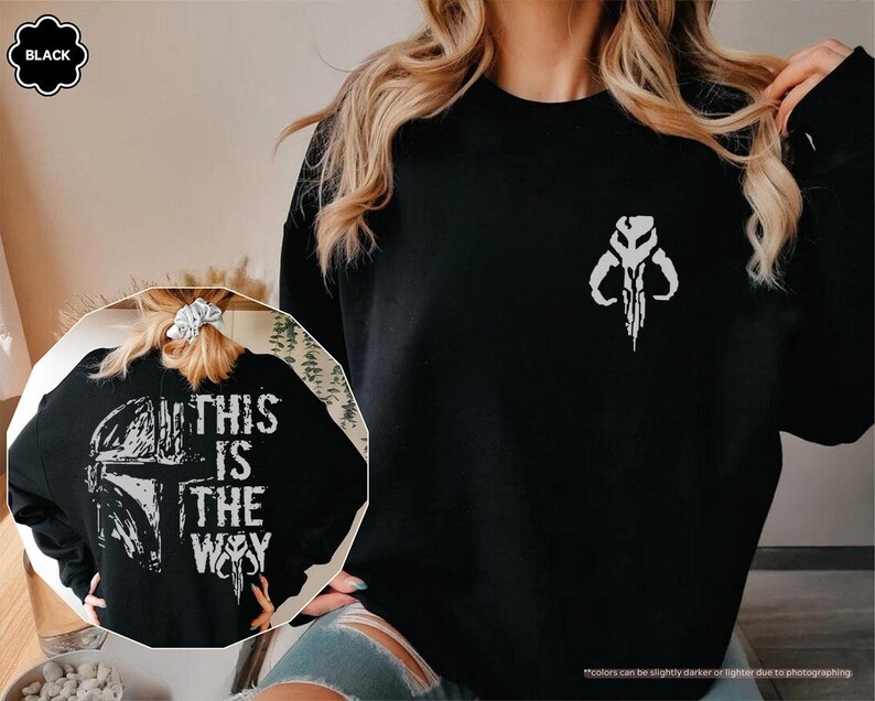 May include: Black sweatshirt with a white graphic print of a Mandalorian symbol and the text "This is the way".