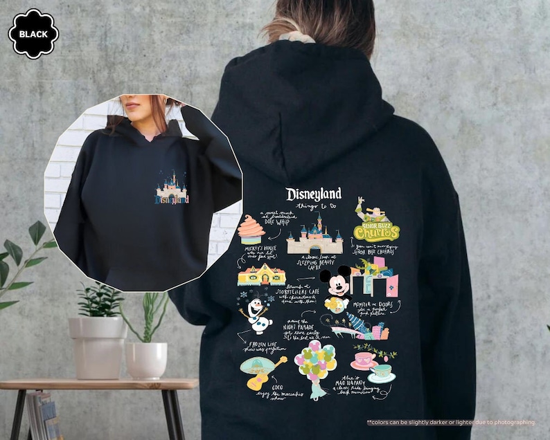a woman wearing a black disneyland hoodie