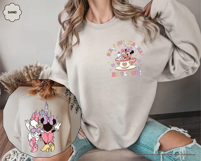 a woman wearing a sweatshirt with minnie mouse on it