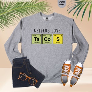 a sweatshirt with the words welders love and a pair of sneakers