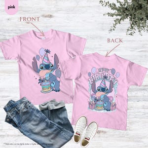 May include: Two pink t-shirts featuring a cartoon alien celebrating a birthday. The front of the shirt shows the alien with a cake and balloons. The back of the shirt says "It's my birthday".