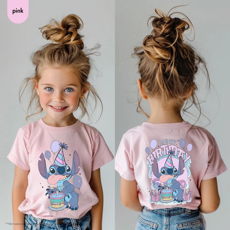 May include: A pink t-shirt with a cartoon character design, including a party hat, cake, and balloons. The front of the shirt shows the character, and the back says "It's My Birthday". The t-shirt is worn by a young girl.