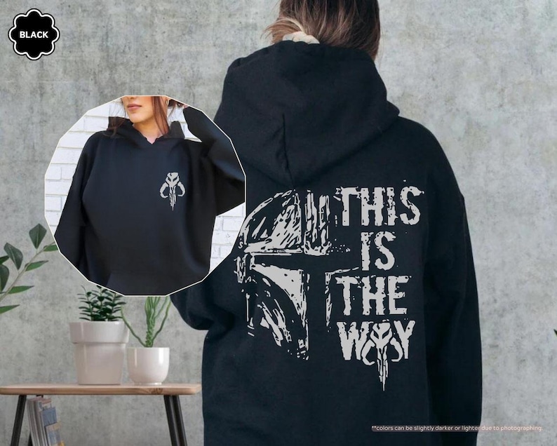 May include: Black hooded sweatshirt with a white graphic of a Mandalorian helmet and the text "This is the Way".