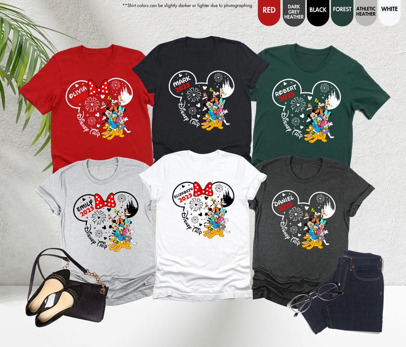 May include: Six personalized t-shirts with a Mickey Mouse ear design. Each shirt features a different name, the year 2023, and the text "Disney Trip". The shirts are available in red, black, white, grey, and green.