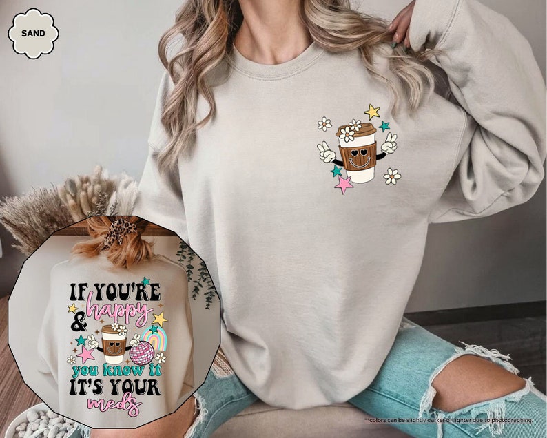 a woman wearing a sweatshirt with a cup of coffee on it