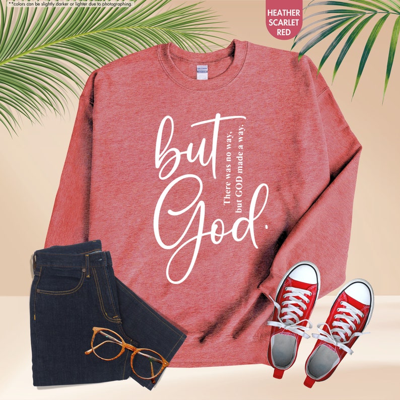 a red sweatshirt with a pair of sneakers and a pair of sunglasses