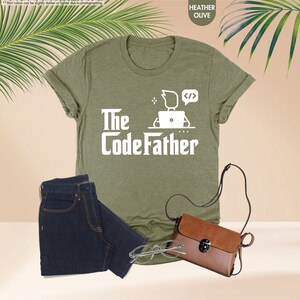 a t - shirt that says the codefather next to a pair of jeans