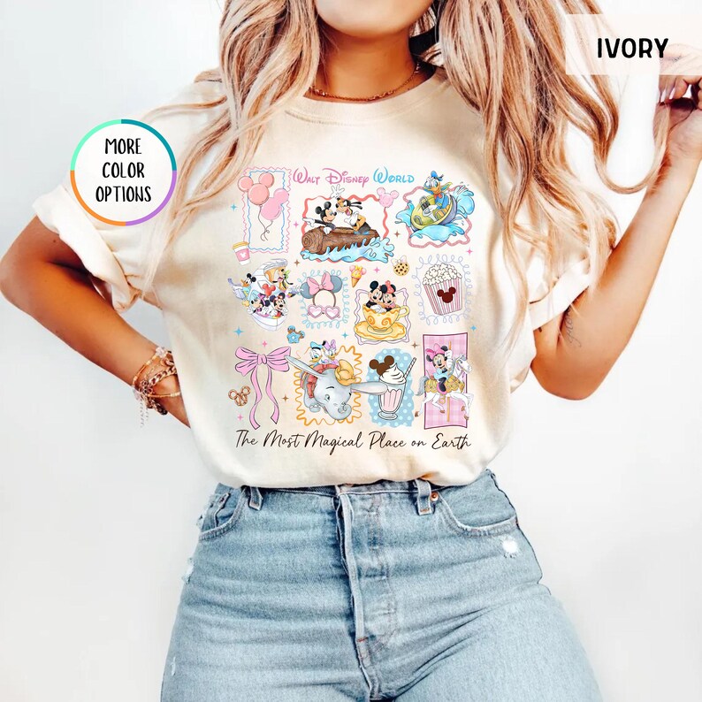 May include: Ivory-colored t-shirt featuring a colorful collage of Disney characters and attractions. The design includes Mickey and Minnie Mouse, Dumbo, and other iconic characters. Text on the shirt reads "Walt Disney World" and "The Most Magical Place on Earth."