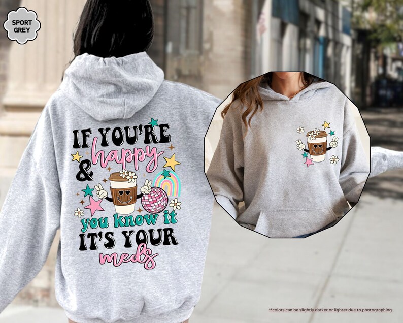 a woman wearing a gray hoodie with a cup of coffee on it
