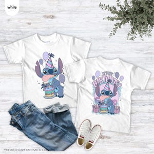 May include: Two white t-shirts with a cartoon character design, a party hat, cake, and balloons. One shirt says "It's my birthday". The image also includes blue jeans and white trainers.