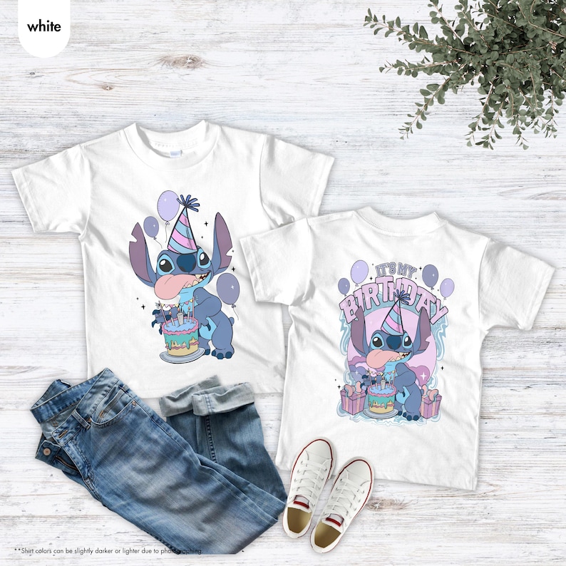 May include: Two white t-shirts with a cartoon character design, a party hat, cake, and balloons. One shirt says "It's my birthday". The image also includes blue jeans and white trainers.