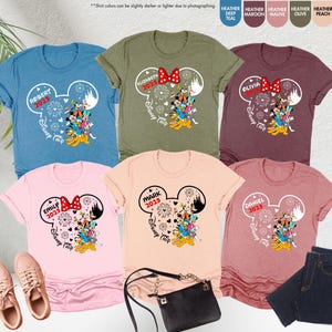 May include: Six different color t-shirts with a white Mickey Mouse head design. Each shirt has a name and year printed on it. The shirts say "Robert 2025", "Elizabeth 2025", "Olivia 2025", "Emily 2025", "Mark 2025", and "Daniel 2025".