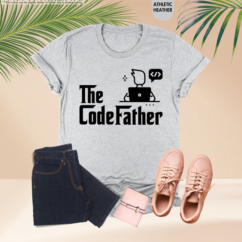 a t - shirt that says the codefather next to a pair of jeans