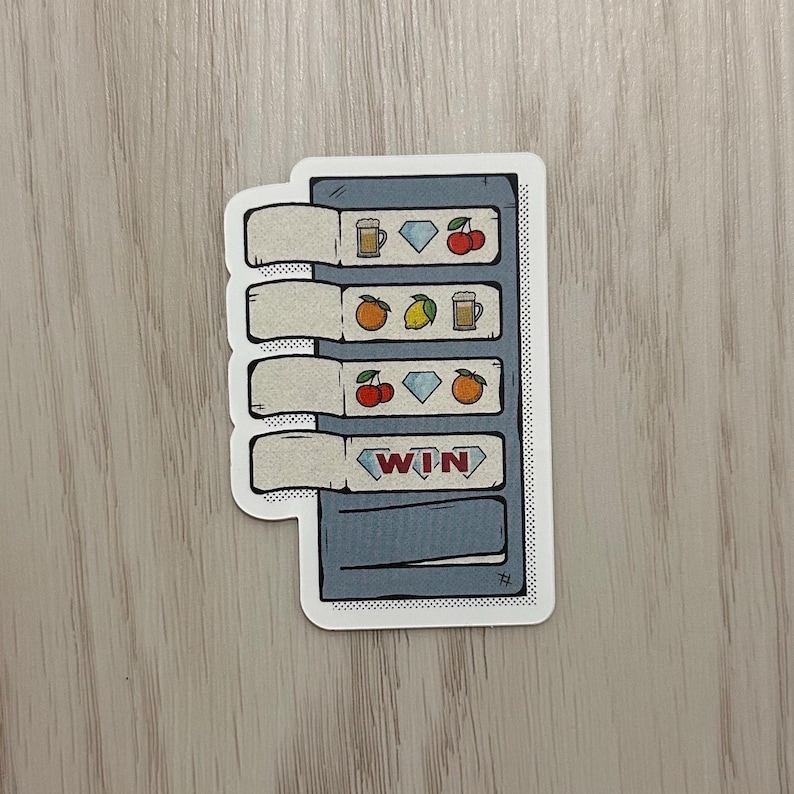 May include: A sticker featuring a cartoon slot machine design. The machine has four reels with symbols like cherries, diamonds, oranges, lemons, and beer mugs. The bottom reel displays the word "WIN" in a red banner.
