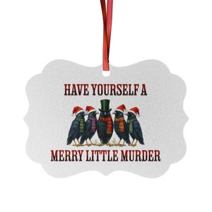 May include: A white Christmas ornament with a red ribbon. It features five black crows, each wearing a Santa hat and a scarf. The text on the ornament reads "Have Yourself a Merry Little Murder."