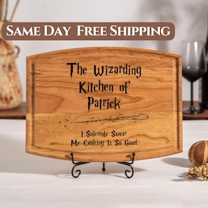 May include: A wooden cutting board with a curved top and a black metal stand. The board is engraved with the text "The Wizarding Kitchen of Patrick" and "I Solemnly Swear My Cooking Is So Good".