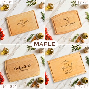 May include: Four maple wood cutting boards with engraved names and dates. The boards vary in size, with the largest measuring 17 inches by 11 inches. Each board has a different design, including floral accents and family names. The boards are surrounded by olive oil, tomatoes, and walnuts.
