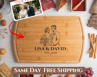 May include: A rectangular bamboo cutting board with a carved image of a couple and the text "LISA & DAVID EST. 2026". The board also features a photo and the text "YOUR PHOTO". The image is surrounded by food items.