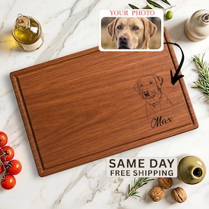 May include: A rectangular wooden cutting board featuring a laser-engraved line art illustration of a dog's head and the name Max. An inset box displays a photograph of a yellow Labrador retriever with the text YOUR PHOTO above it.