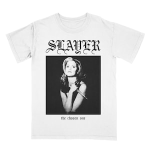 May include: White t-shirt featuring a black and white image of a woman holding a knife. The text "SLAYER" is above the image and "the chosen one" is below the image.