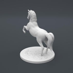 May include: White ceramic figurine of a horse rearing up on its hind legs. The horse has a flowing mane and tail. The figurine is on a round base with a textured surface.