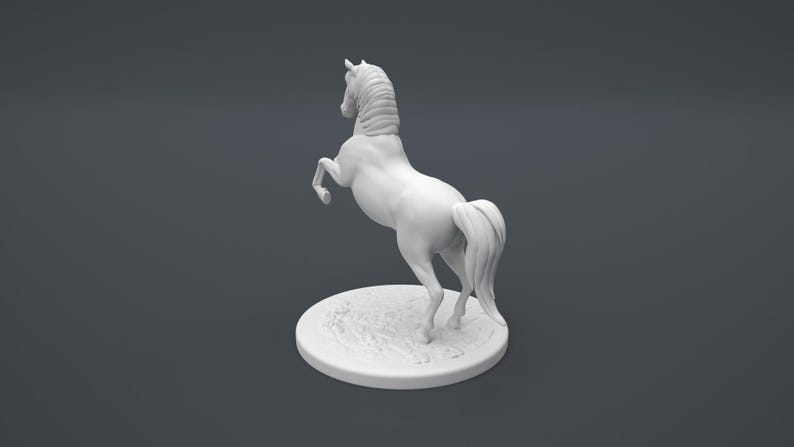 May include: White ceramic figurine of a horse rearing up on its hind legs. The horse has a flowing mane and tail. The figurine is on a round base with a textured surface.