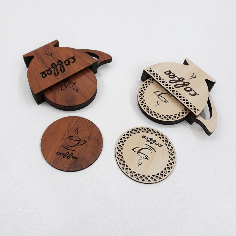 May include: Set of four wooden coasters featuring a coffee pot design. The coasters are made of natural wood and have a brown and light brown color scheme. The coasters are engraved with the word "coffee" and a coffee cup design.