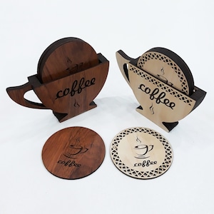 May include: Set of six wooden coasters with a coffee cup design. The coasters are in two different colors, brown and natural wood. The coasters are stacked in a cup shape, with the word "coffee" engraved on the side.