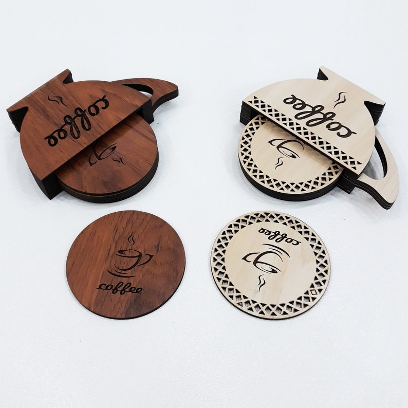 May include: Four wooden coasters with a coffee pot design. Two coasters are brown with the word "coffee" and a coffee cup design. Two coasters are light brown with the word "coffee" and a coffee cup design.