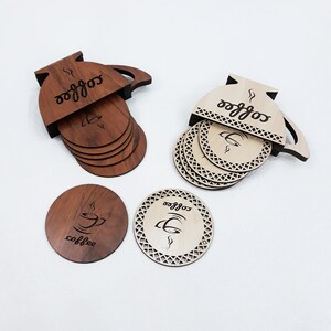 May include: Set of six wooden coasters featuring a coffee pot design. The coasters are made of natural wood and have a laser-etched design. The coasters are perfect for protecting your furniture from hot drinks and adding a touch of style to your home.