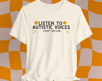 May include: White t-shirt with the text "LISTEN TO AUTISTIC VOICES *EXCEPT FOR ELON" and two yellow smiley faces.