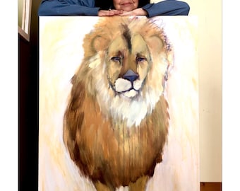 May include: A woman with dark hair and a pink headband leans over a canvas painting of a lion. The lion is painted in shades of brown, yellow, and white, with a light background.