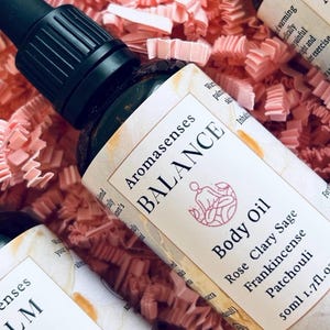 Massage oil bottle in pink packaging