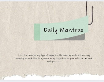 May include: A light green paper note with the text "Daily Mantras" written in black. The note is attached to a white background with a torn edge.