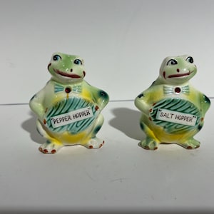 FROGS Salt and pepper shakers with Frogs titled “Salt Hopper” and “Pepper Hopper”. Made in ceramic, no date, unknown manufacture (see pics).