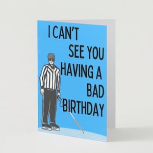 May include: A blue birthday card with a cartoon referee holding a white cane. The card reads "I can't see you having a bad birthday."