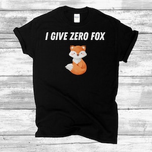 May include: Black t-shirt with white text that reads "I give zero fox" and a cartoon image of a fox.