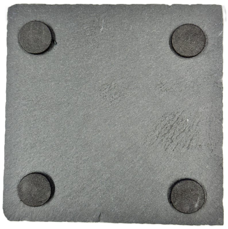 May include: A square, gray slate coaster with four round, dark gray pads on the corners. The coaster has a textured surface and is designed to protect surfaces from drink condensation.