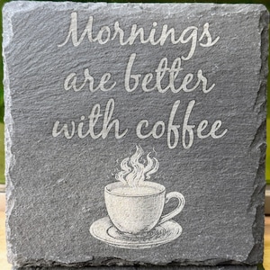 May include: A gray slate coaster with the text "Mornings are better with coffee" and a white illustration of a steaming cup of coffee.