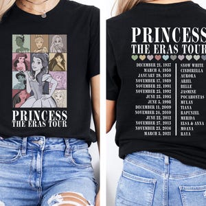 May include: Black t-shirt with a graphic of Disney princesses and the text "Princess The Eras Tour". The back of the shirt lists the Disney princesses and their release dates.