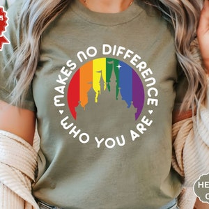 May include: A green t-shirt with a white graphic of a rainbow circle with a castle inside. The text around the circle reads "Makes no difference who you are."