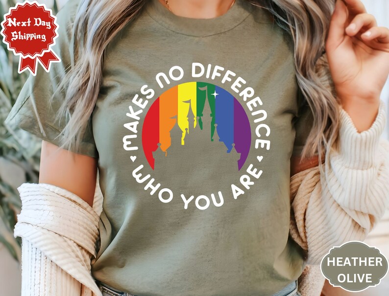 May include: A green t-shirt with a white graphic of a rainbow circle with a castle inside. The text around the circle reads "Makes no difference who you are."