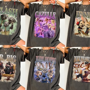 May include: Six dark grey t-shirts featuring characters from the animated film "Zootropolis." Each shirt displays a different character or group of characters with their names in a vintage-style font. The characters include Flash, Gazelle, Finnick, Mr. Big, Judy Hopps, and Duke Weaselton.