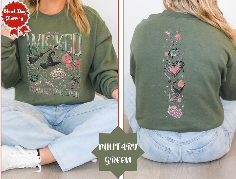 May include: A green sweatshirt with a graphic print of a witch, a crown, and the words "Wicked Changed For Good".