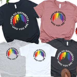 May include: Four t-shirts with a rainbow castle graphic and the text "Makes no difference who you are." The shirts are in different colors: black, gray, white, and heather gray.