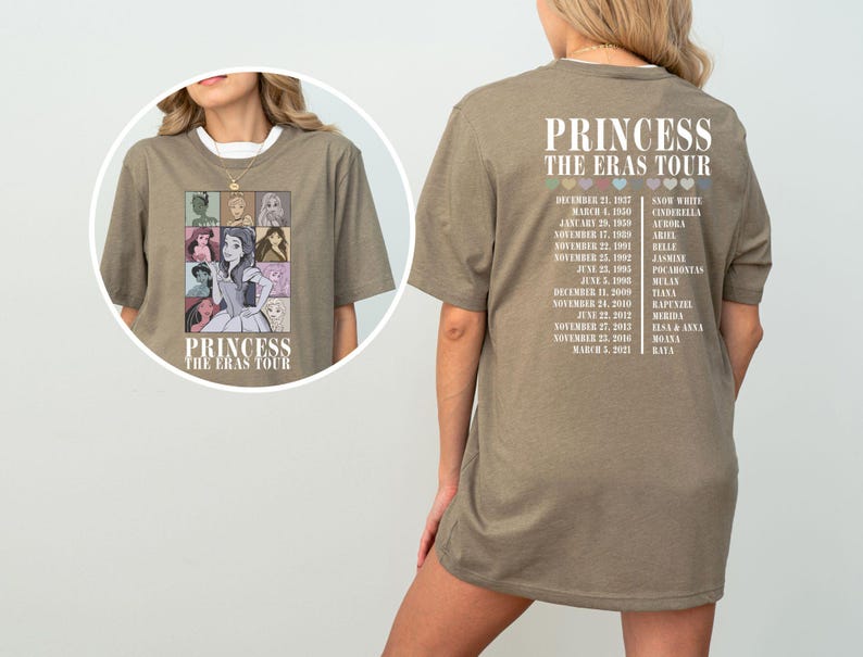 May include: A light brown t-shirt with a graphic of Disney princesses on the front and a list of tour dates and princess names on the back. The text on the shirt reads "Princess The Eras Tour".